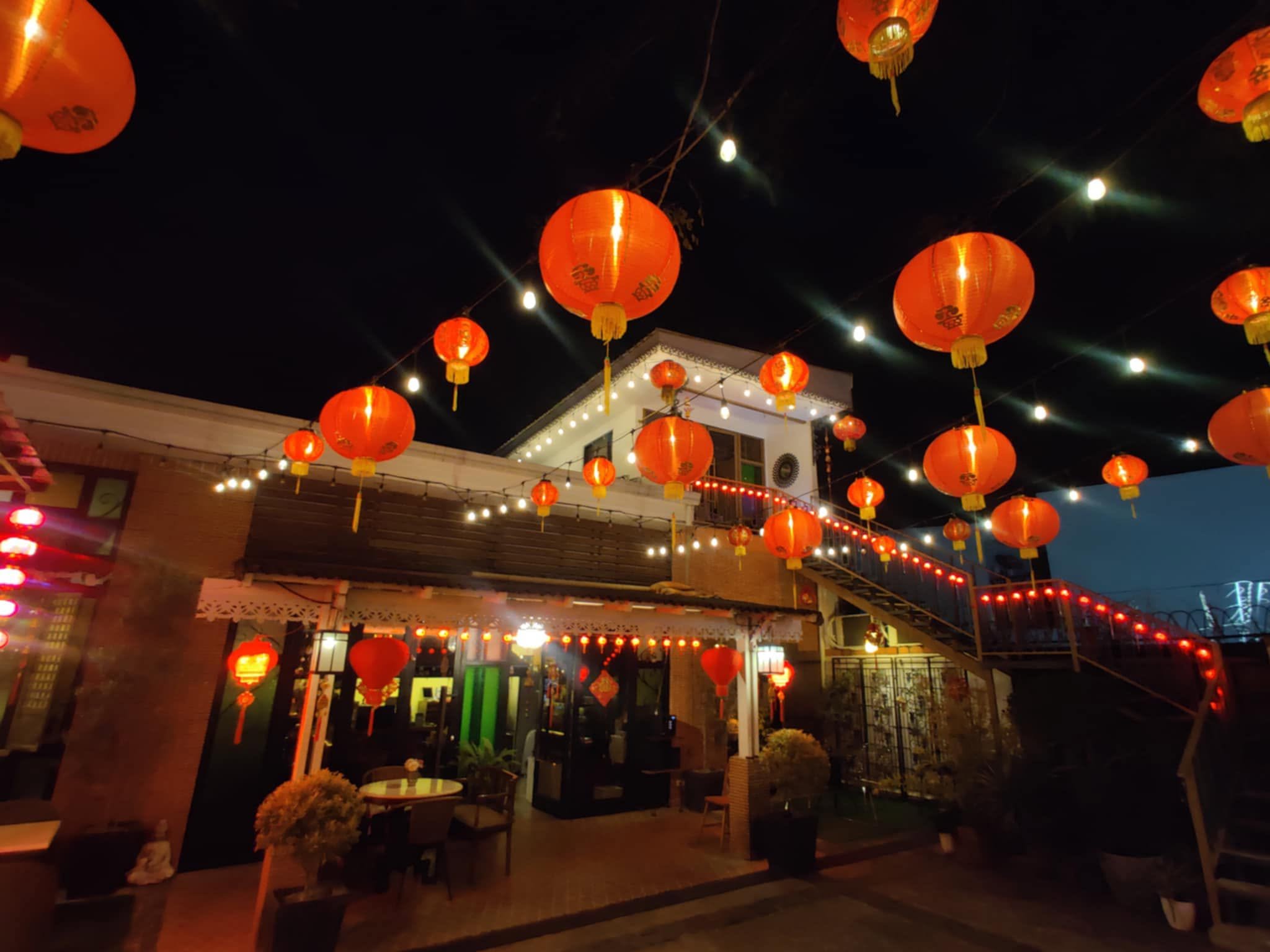 Red lanterns glowing above the courtyard at night