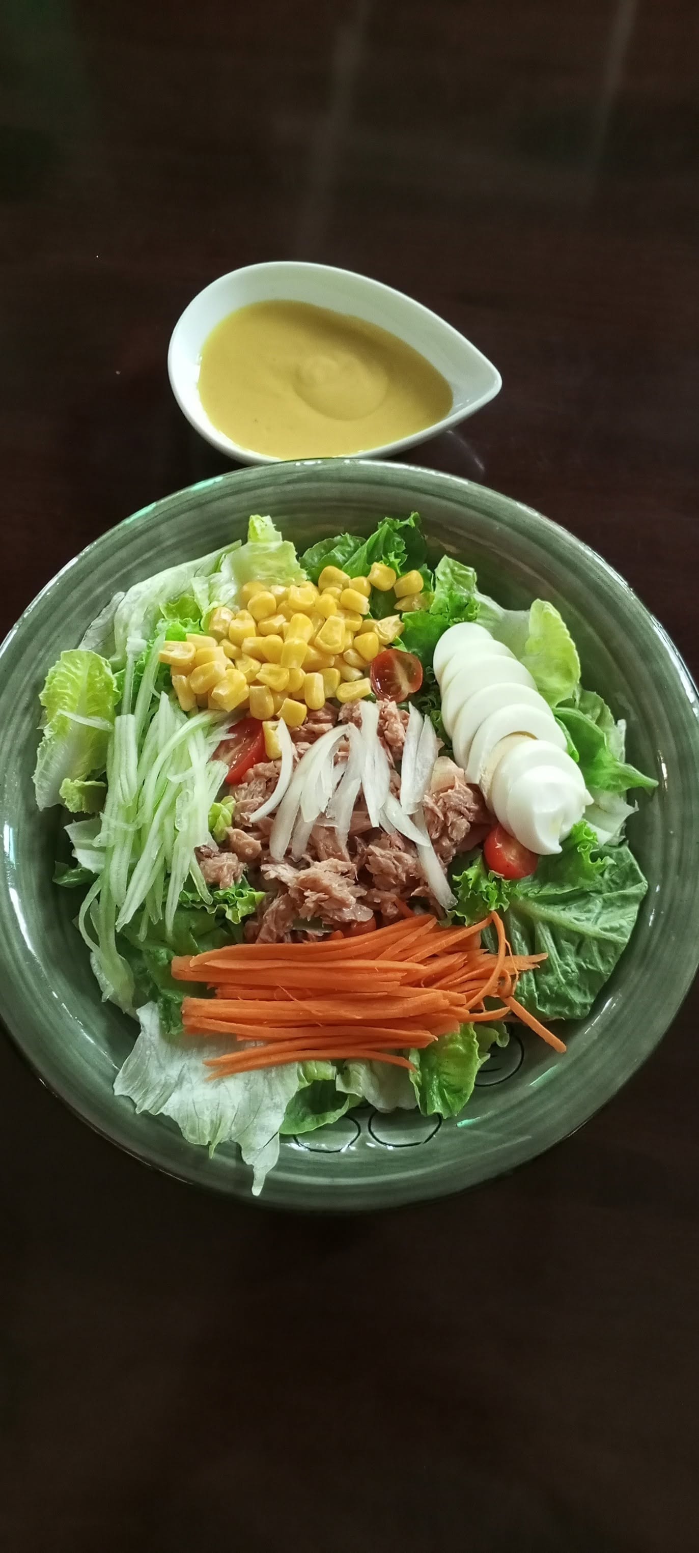 Fresh tuna salad with greens, egg, corn, and honey-mustard dressing
